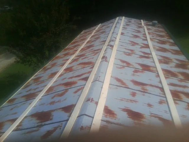 Rusted metal roof panels with new wood purlins before replacement — Storm Damage Roof Repair in Chilton by Roofing Brothers