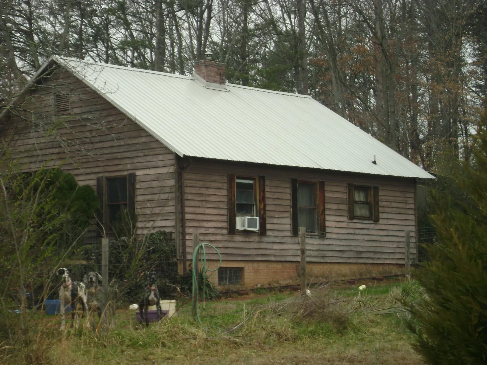 White metal roof on an old wood sided farmhouse, from a Metal Roof Installation job in Chilton